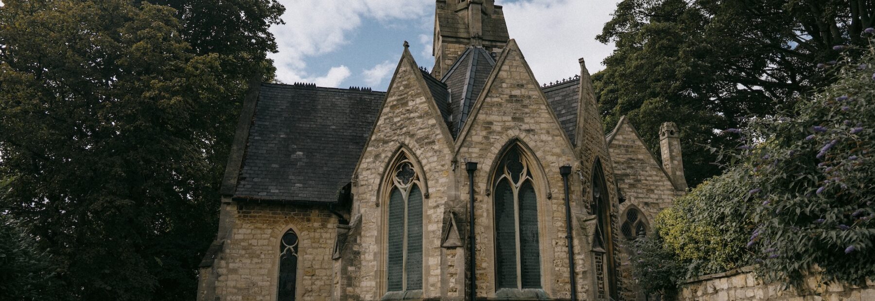 The Old Palace interior — a warm lounge with fireplace and Gothic windows